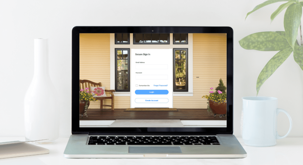 Laptop on a white desk displaying a secure sign-in page with fields for email and password. A potted plant, white vase, and mug are next to the laptop. Importance of Tenant Web Access in Property Management