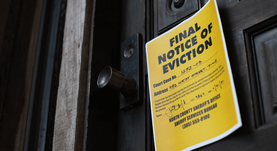 Yellow eviction notice taped to a wooden door, titled "Final Notice of Eviction," with case number, address, and sheriff's contact details visible.