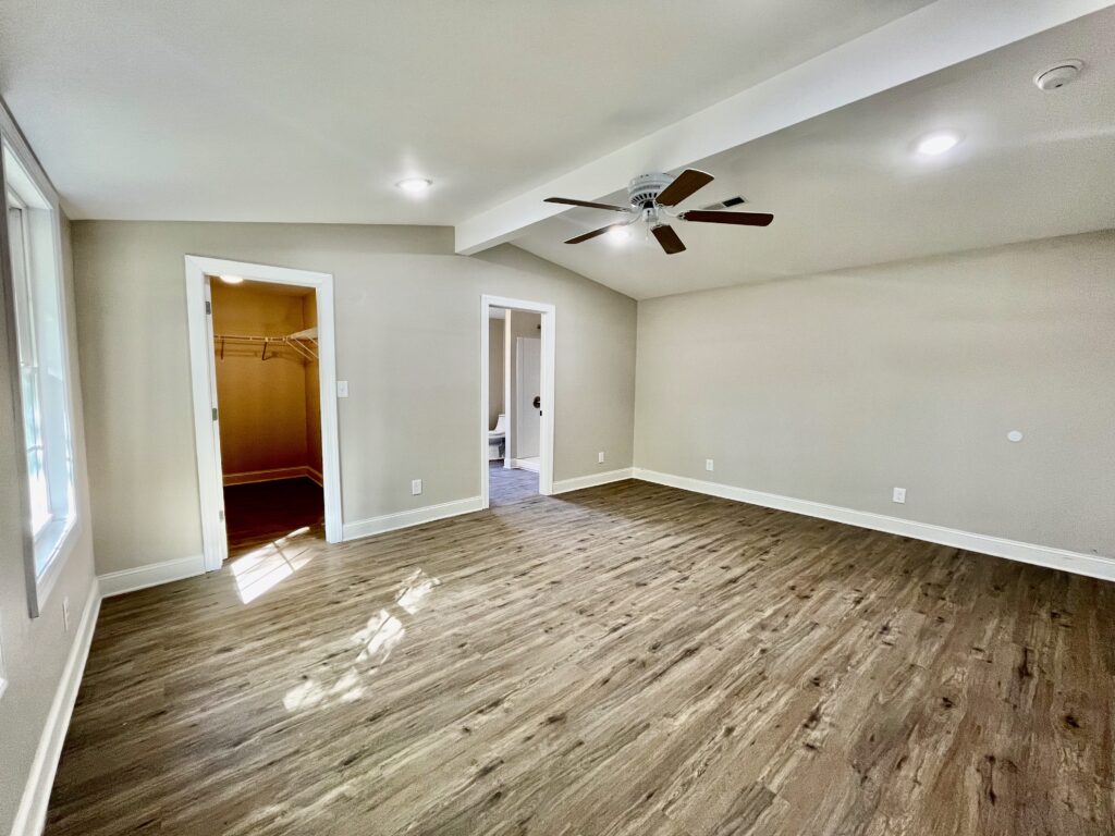 empty room with wooden floor with window and closet