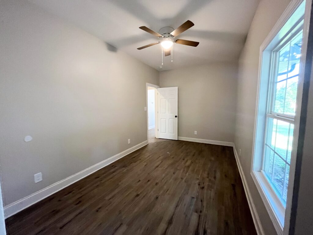 Empty room with window and white door