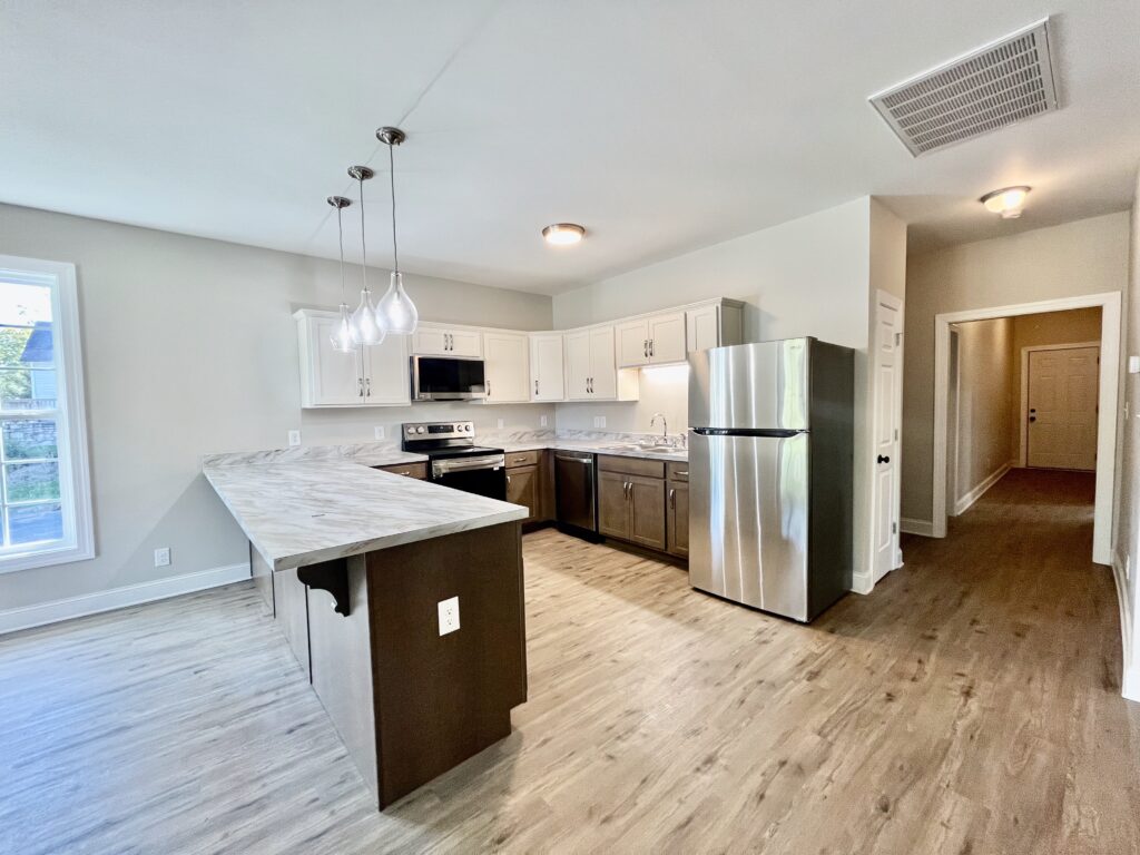 kitchen with fridge, microwave oven and cooking range