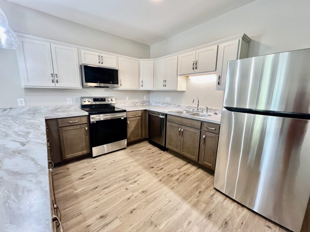 kitchen with fridge, microwave oven and cooking range
