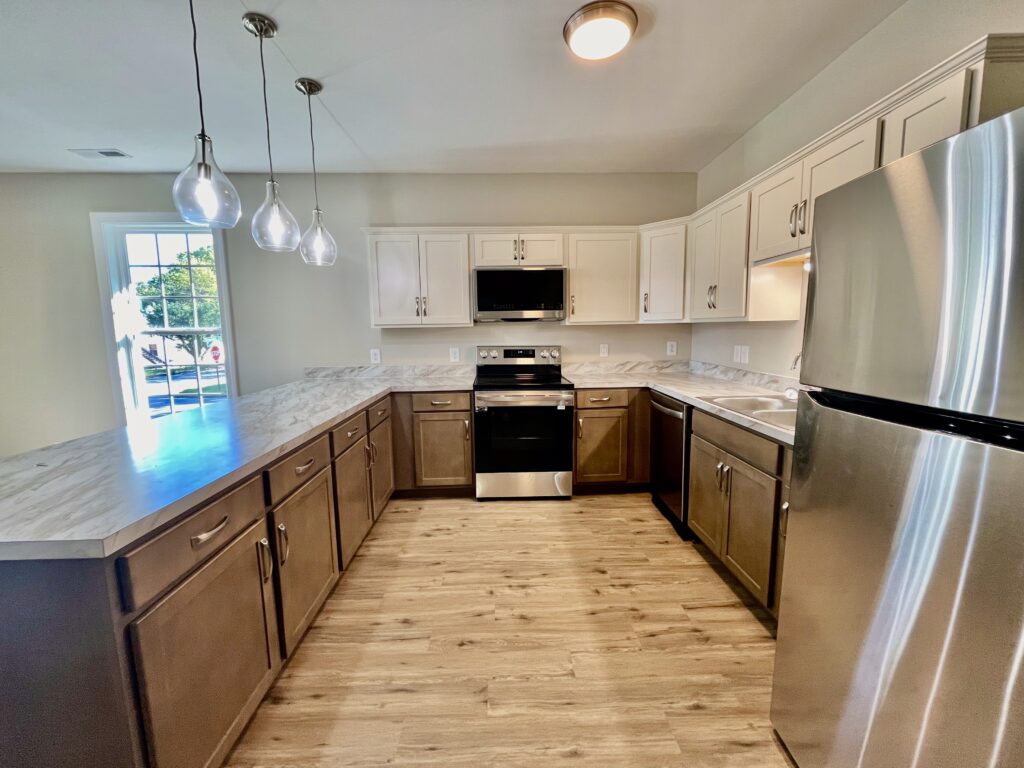 kitchen with fridge, microwave oven and cooking range