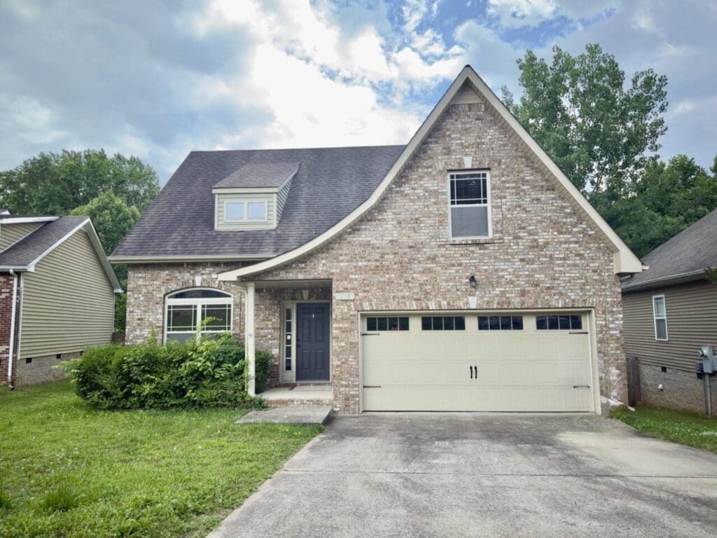 beautiful house with garage and lawn